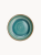 A top-down view of a round ceramic plate featuring a glossy teal and turquoise glaze with concentric swirl patterns and a brown rim.