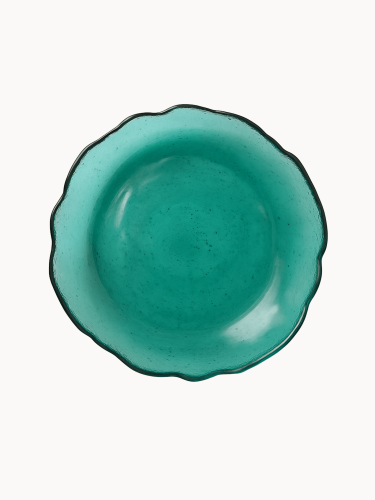 A top-down view on a vibrant teal cake stand with a distinct ruffled edge.